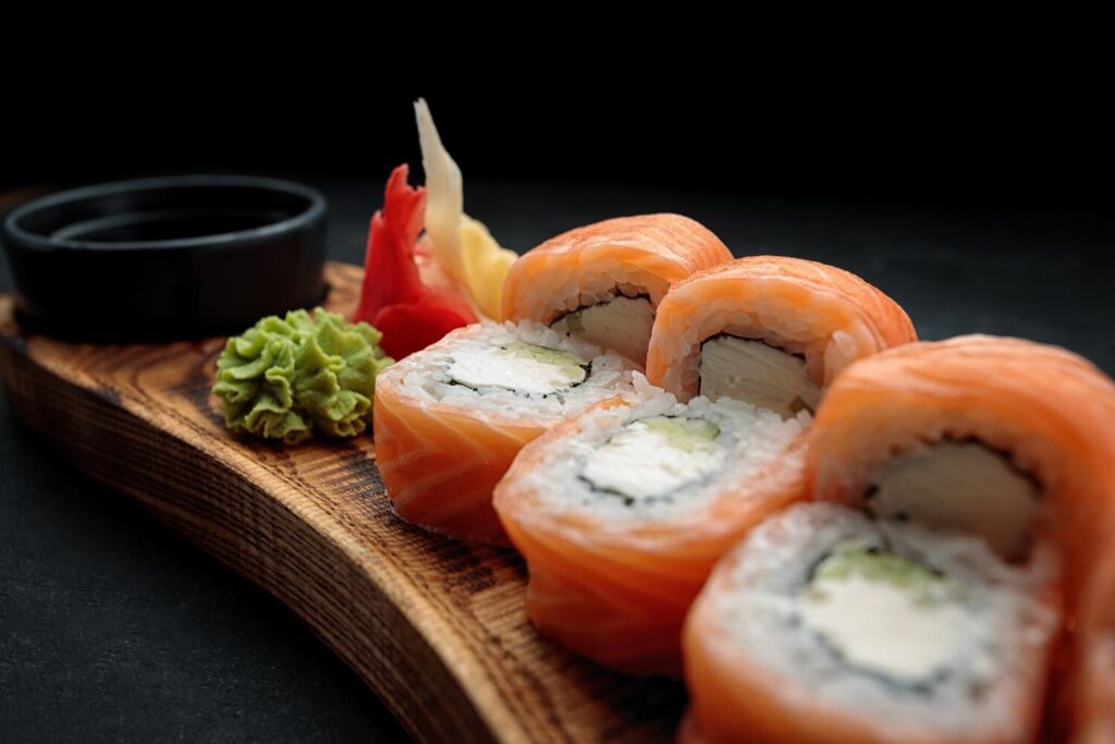 Sushi roll philadelphia with wasabi ginger wooden board with leaf bamboo dark background 210632 2837 Sushi roll philadelphia with wasabi ginger wooden board with leaf bamboo dark background 210632 2837