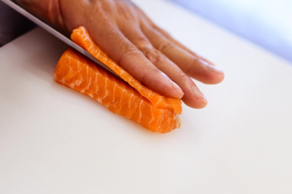 Faceless shot chef cutting salmon filet restaurant kitchen close up view 1084977 375 Faceless shot chef cutting salmon filet restaurant kitchen close up view 1084977 375